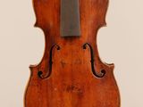 an old violin with a bow hanging from the back
