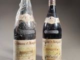 two bottles of wine sitting next to each other on a table