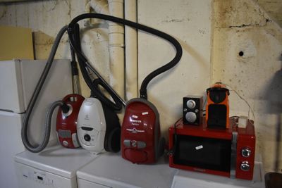 many appliances and appliances sitting on a shelf in a room