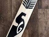 a close up of a cricket bat on a wooden floor