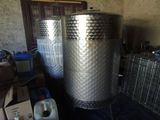 two metal tanks sitting next to each other in a room