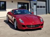 a picture of a red sports car parked in front of a building