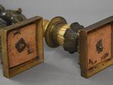pair of antique brass and wood cufflinks with numbers on them