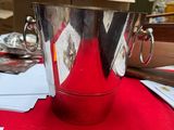 a silver ice bucket sitting on top of a red table