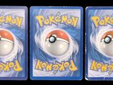 three plastic pokemon toys are shown in a row on a black background