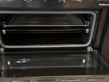 a black oven with the door open and the door open