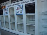 many shelves with signs on them in a store