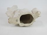a white ceramic turtle that is sitting on a white surface
