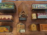 many different tins on a wooden table with a clock