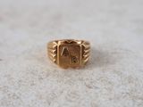 an image of a gold ring with the letter a on it
