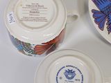two cups and saucers are sitting next to each other on a table
