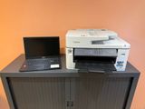 a laptop and a printer sitting on top of a cabinet