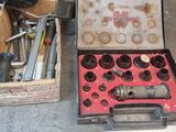 a box of tools sitting on the floor next to a box of tools
