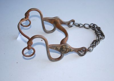 a pair of scissors on a chain on a table