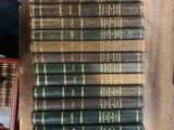 several old books are stacked on top of each other on a table