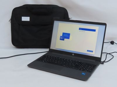 a laptop computer sitting next to a bag on a table