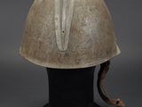 an old helmet is sitting on top of a black base