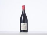 a bottle of red wine sitting on top of a table