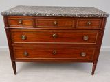 a marble top chest of drawers on display in a room