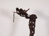 a statue of a woman holding a bird on a chain