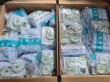 two boxes of diapers are sitting on a table in a room