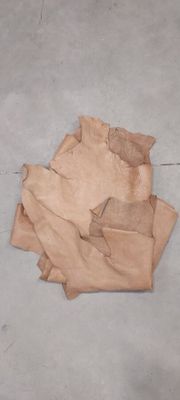 a piece of paper on the ground next to a pair of scissors