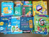 many children ' s books in the box on the table