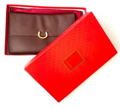 a red box with a black wallet and a red box with a gold ring on it
