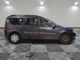 a picture of a grey van parked in a garage