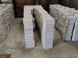 several stacks of boxes are stacked on top of each other in a room