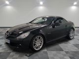 a picture of a black mercedes slk parked in a garage