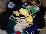 a large pile of clothes that is sitting on a couch