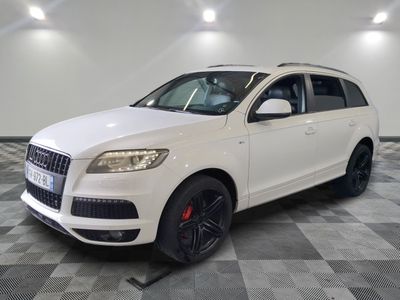 le 4x4 blanc est garé sur un sol en damier dans le garage