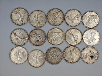 a bunch of silver coins sitting on top of a white surface