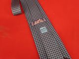 an image of a neck tie on a red surface