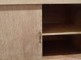 a wooden cabinet with a door and shelves in it