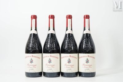 four bottles of wine are lined up on a white surface