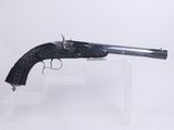 a gun that is sitting on top of a clear stand