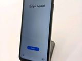 samsung galaxy s9e with a phone on a stand with a message on the screen
