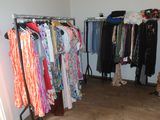a closet with a variety of clothes on a rack