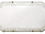 mirrored mirror with a floral design and brass frame