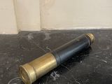 a bullet laying on the floor next to a wall