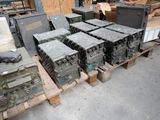 a lot of military equipment on a pallet in a warehouse