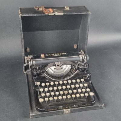 an old typewriter sitting in a case on a table