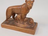 statue of a dog and two cats on a wooden base