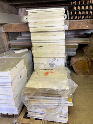 many stacks of books stacked on top of each other in a warehouse