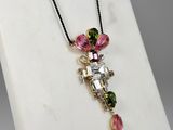 a picture of a necklace with a cross on it