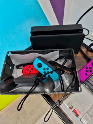 two nintendo wii controllers sitting in a box on a table