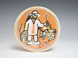 a plate with a picture of a man and a dog
