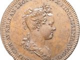 gros plan d'une pièce de monnaie sur laquelle figure une tête de femme